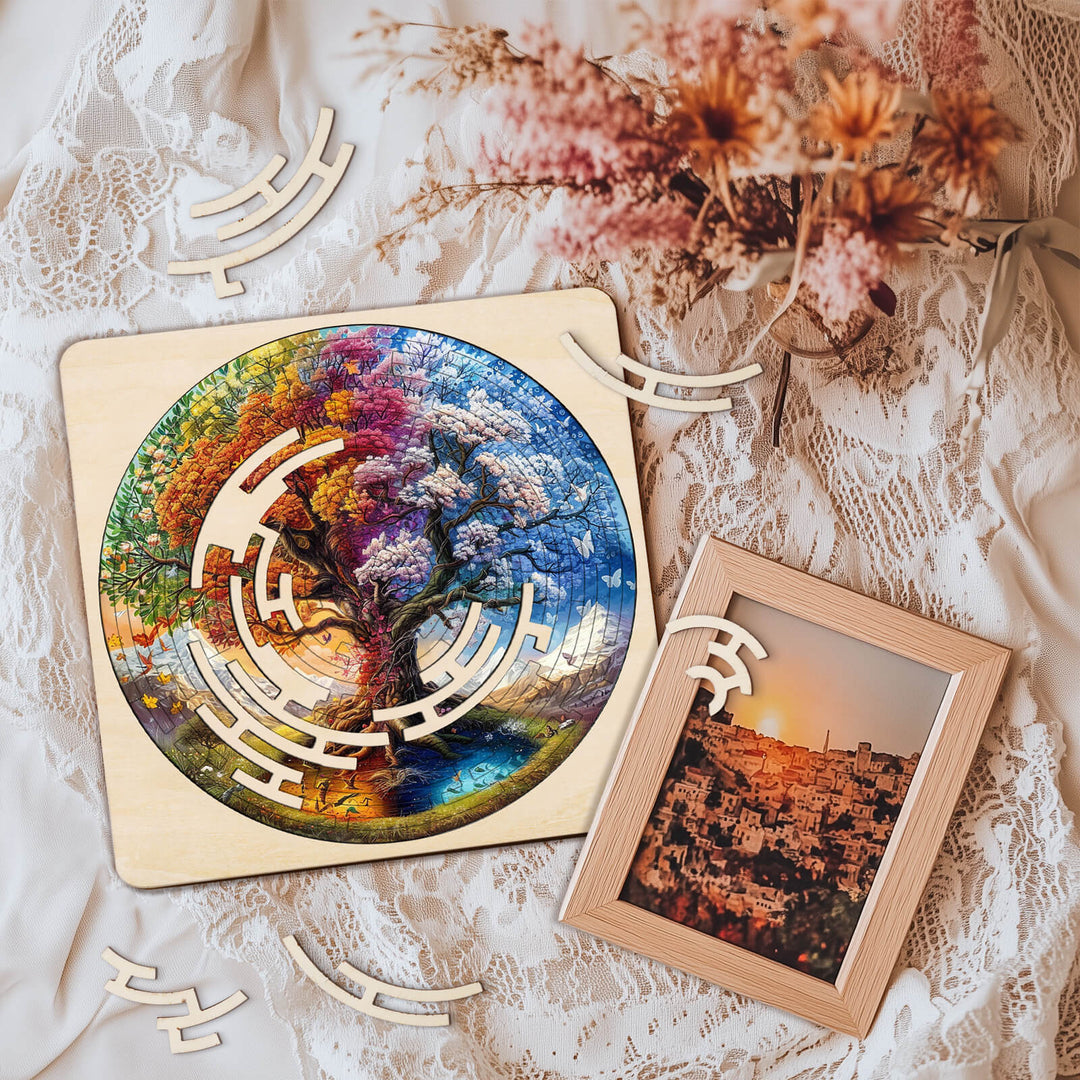 Colorful Tree of Life maze puzzle on a lace backdrop with decorative wooden pieces and a framed photo.