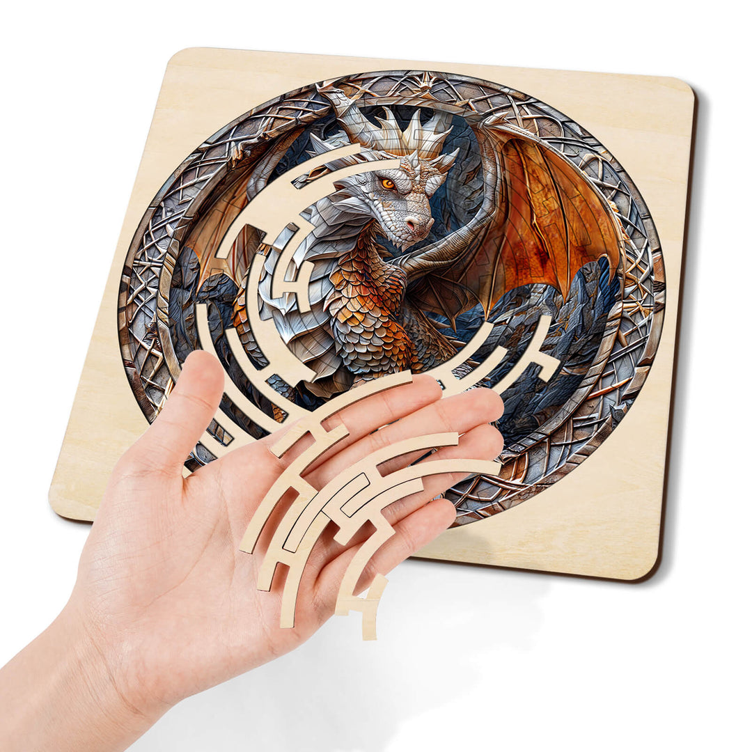 Hand holding wooden maze pieces above a detailed dragon puzzle, ideal for puzzle enthusiasts and mind games.