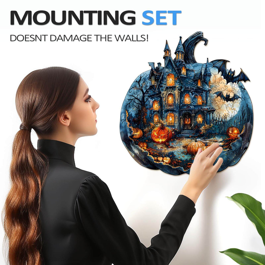 Woman mounting a Halloween Pumpkin wooden jigsaw puzzle on the wall, showcasing intricate details and vibrant colors.