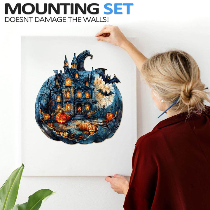 Person hanging a Halloween Pumpkin puzzle artwork with mounting set, highlighting spooky decorations and fall vibes.
