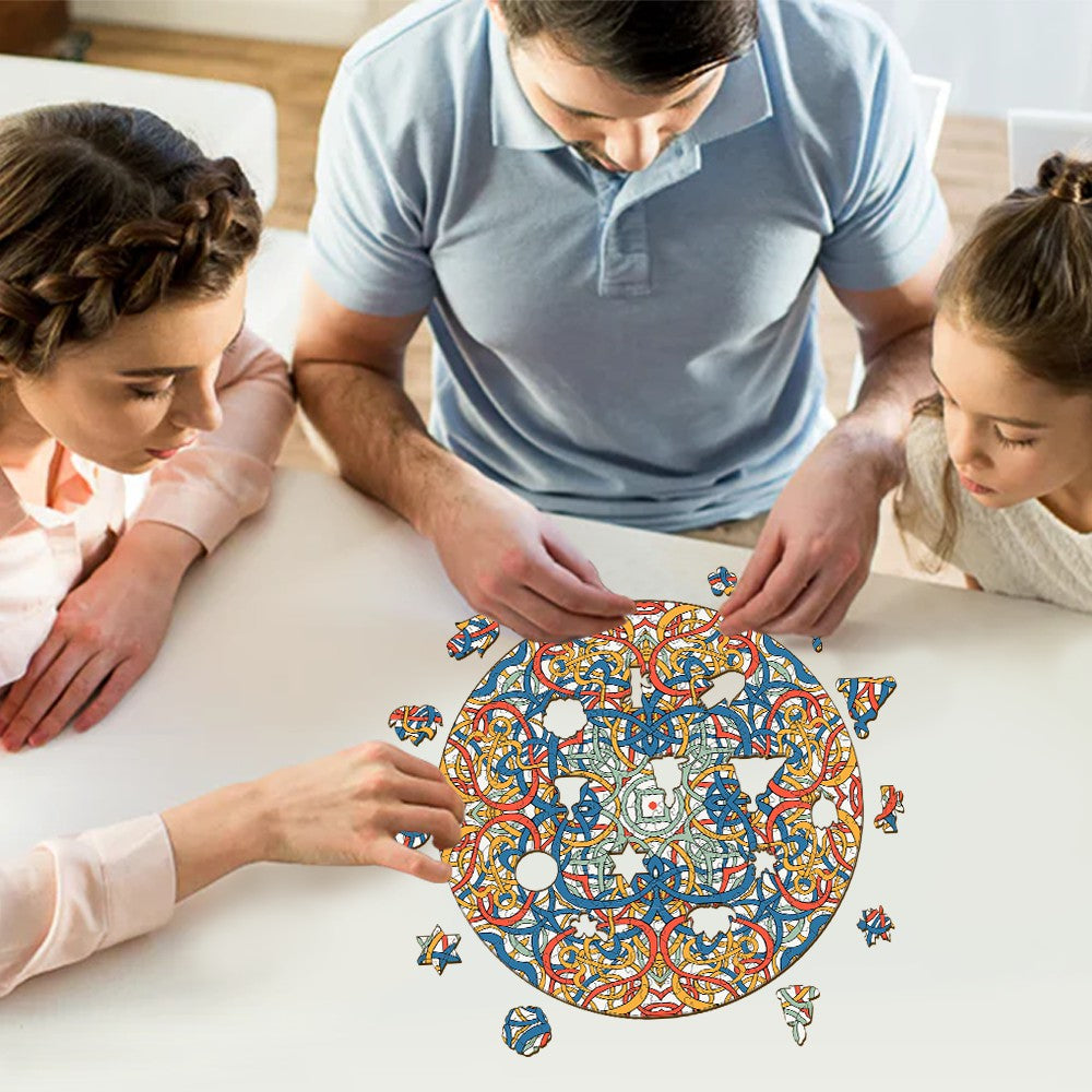 Family enjoying a puzzle of Mandala Celtic Chaos by Lori Anne McKague, featuring colorful intricate doodle art.